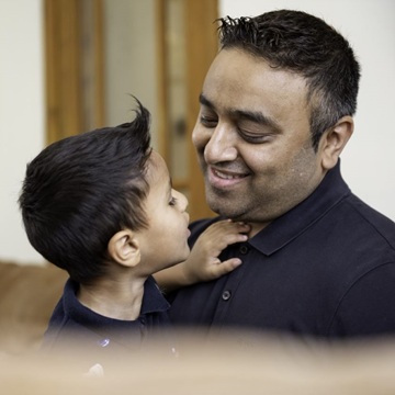 Father and son exchange friendly smiles