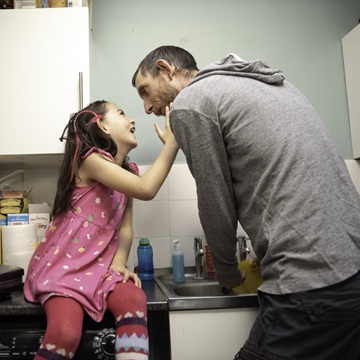 Father and daugher are doing the dishes together