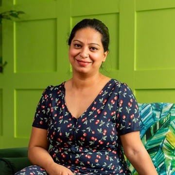 A woman beams at the camera